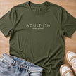 adult-ish under protest T-shirt in military green by Moody Crew